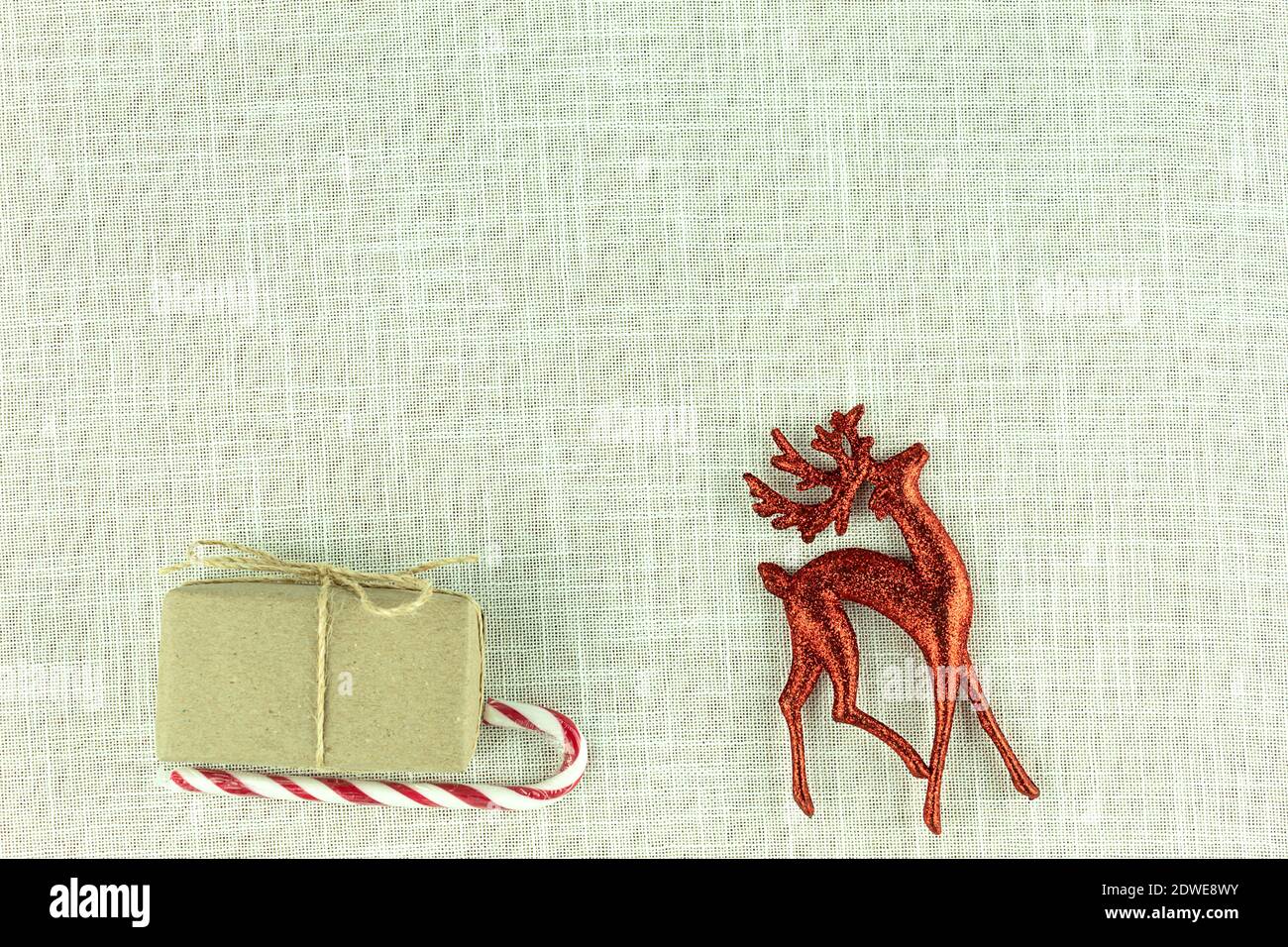 Christmas background on fabric with a deer and sleigh and gifts