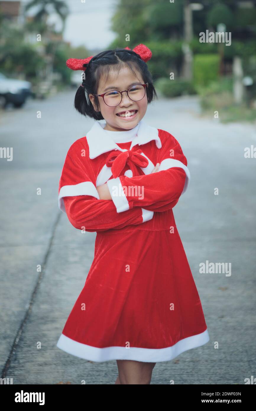 asian girl wearing red suit of santa claus toothy smiling with ...