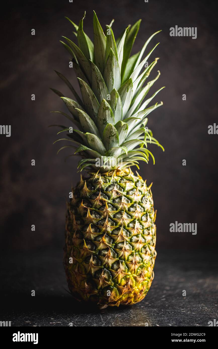 Ripe pineapple. Pineapple on a black table. Stock Photo