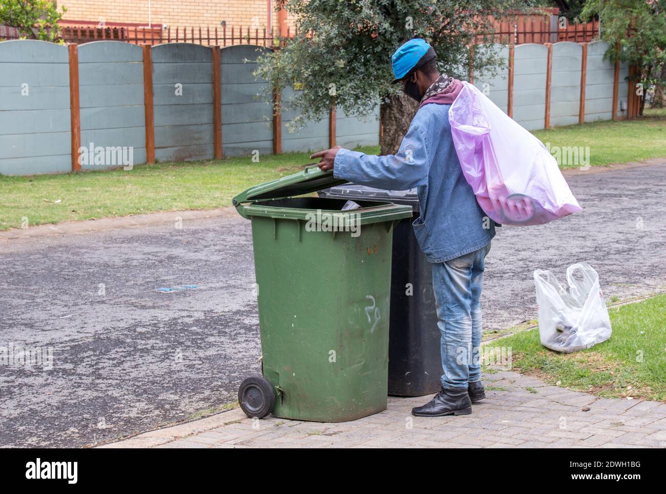 Johannesburg, South Africa - dustbin diving to salvage plastic, food and discarded items by poor and homeless people to make a living Stock Photo