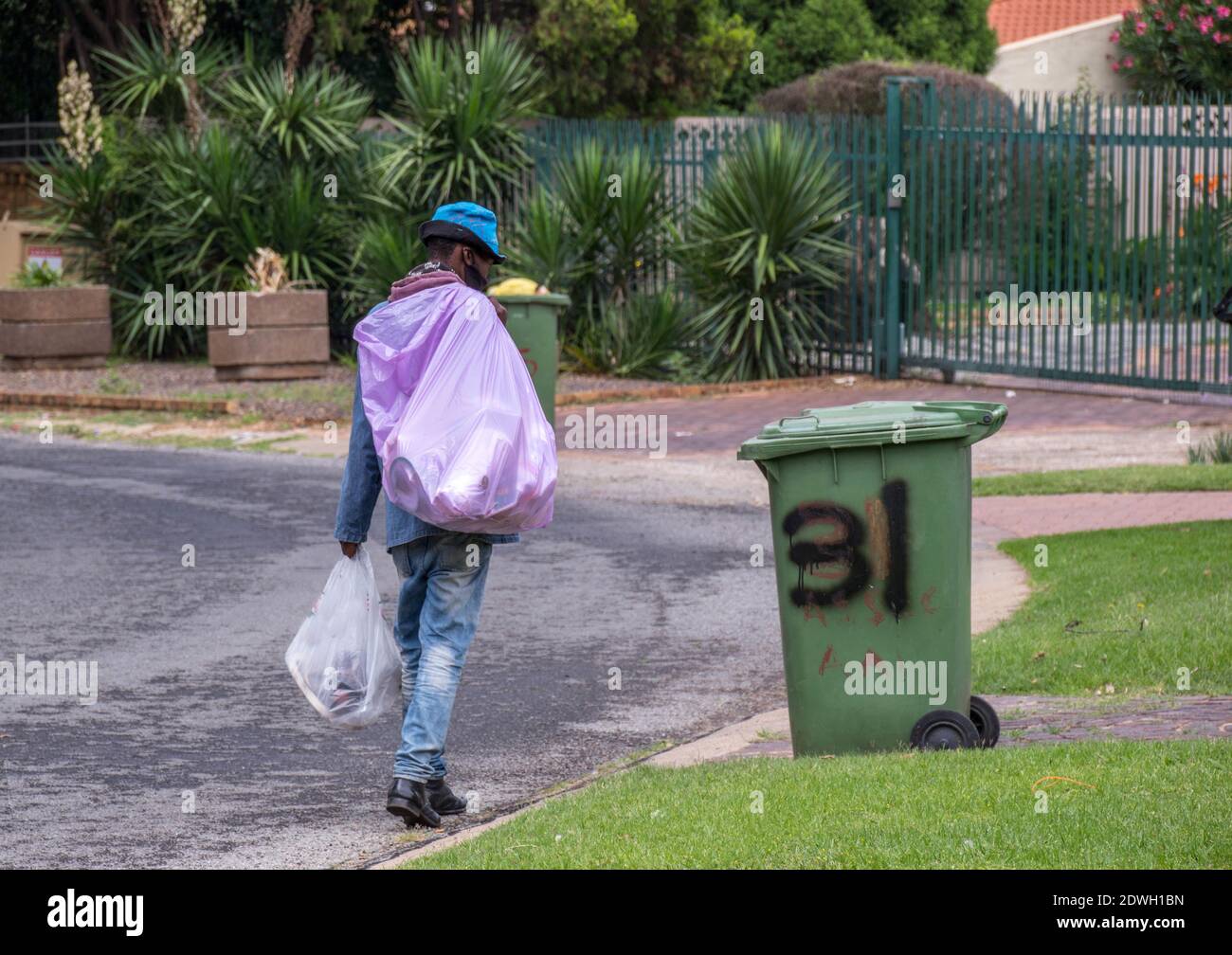 Johannesburg, South Africa dustbin diving to salvage plastic, food