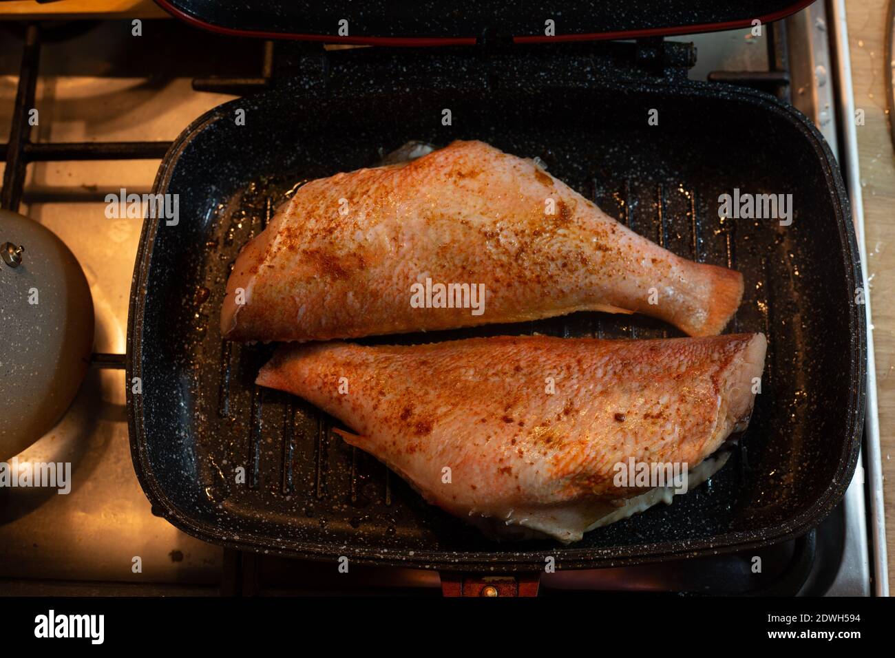 Cooking sea bass in a pan Stock Photo Alamy
