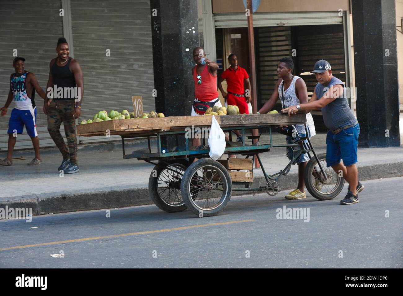 Street vendor selling fruit and vegetables on his bike in the streets ...