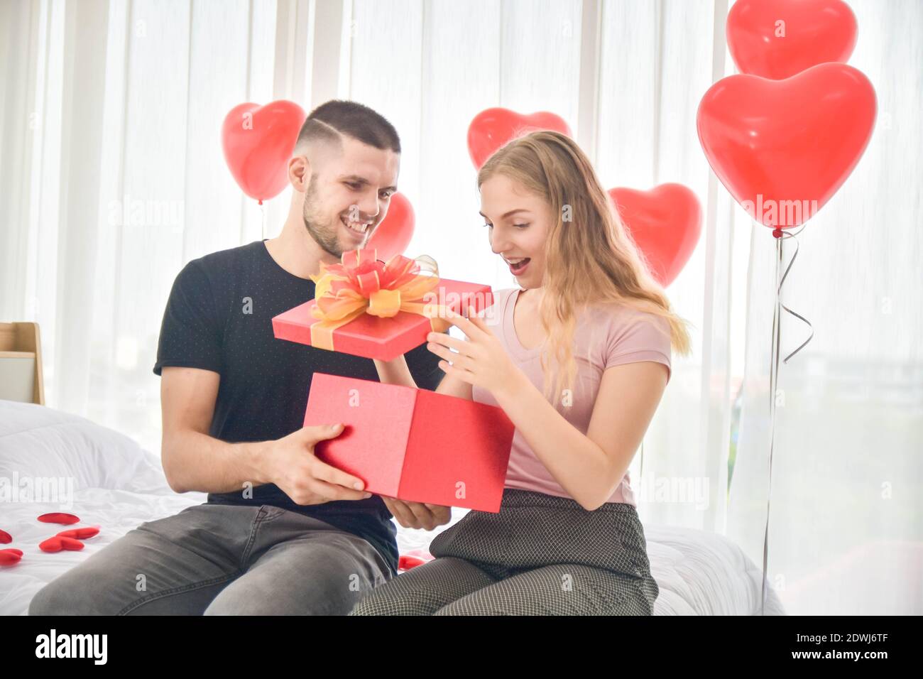 Love Couple giving gift box in bedroom happiness in love Valentine's day  concept Stock Photo - Alamy