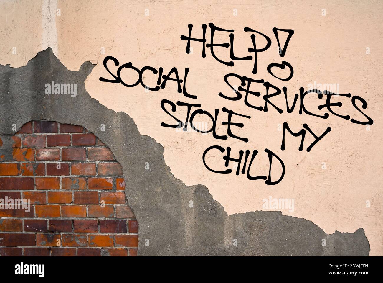 Help! Social Service Stole My Child - handwritten graffiti sprayed on the wall - excessive power of child protective institution, removing and separat Stock Photo