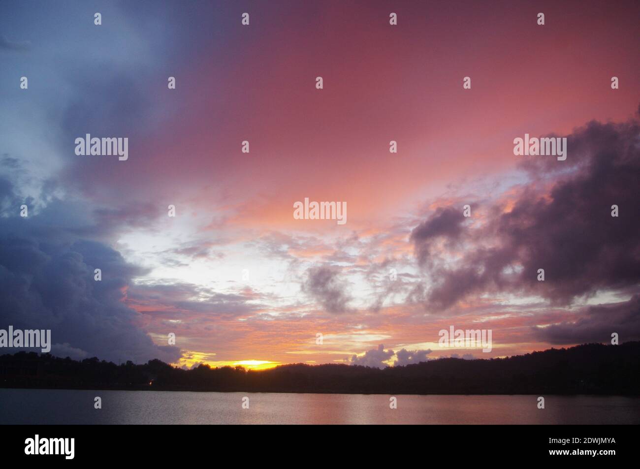 Scenic View Of Dramatic Sky Over Lake During Sunset Stock Photo