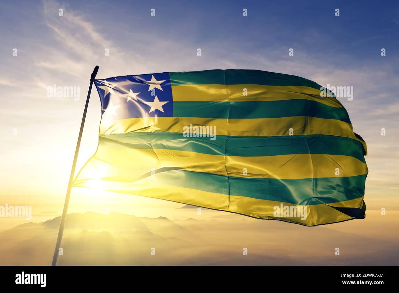 Goias state of Brazil flag waving on the top sunrise mist fog Stock Photo
