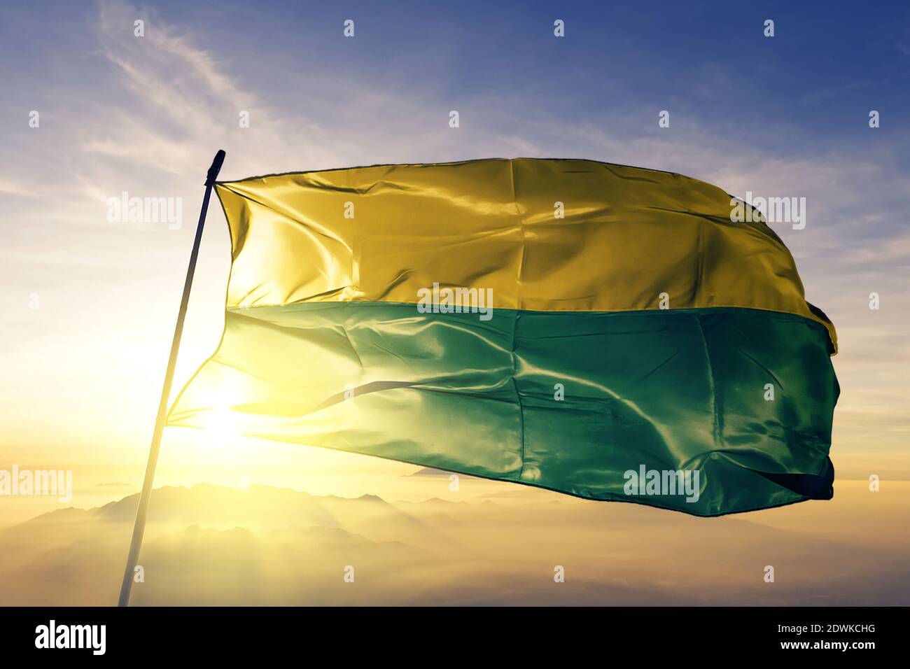 Vichada department of Colombia flag waving on the top sunrise mist fog Stock Photo