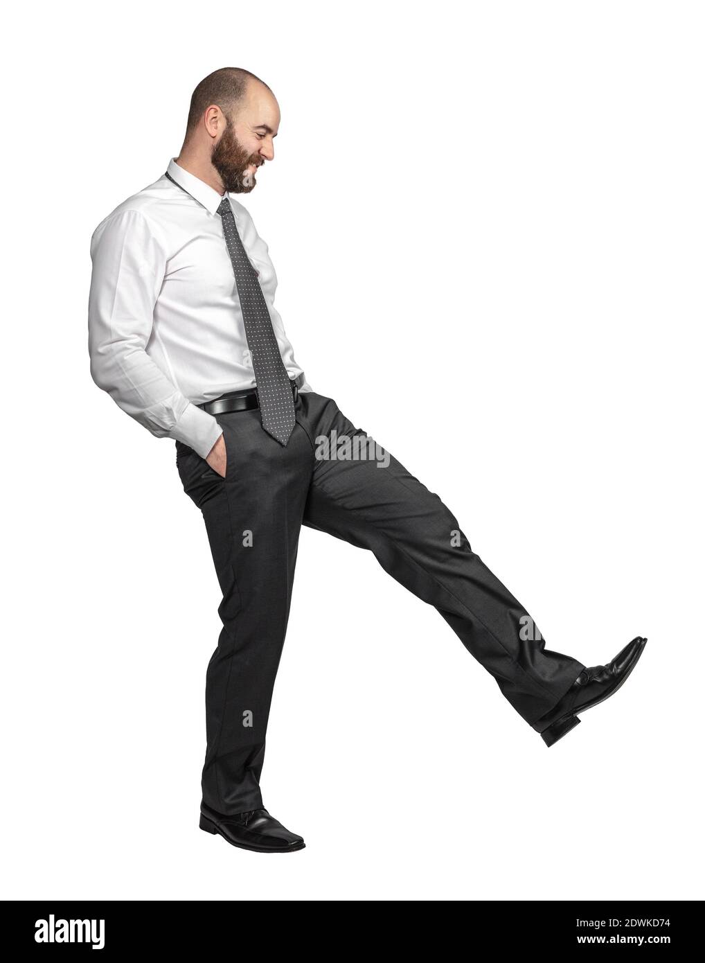 businessman isolated on white hands in pockets and action of kicking Stock Photo