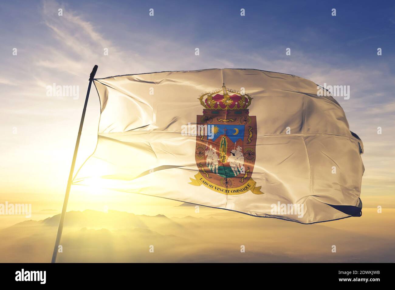 Zacatecas state of Mexico flag waving on the top sunrise mist fog Stock Photo