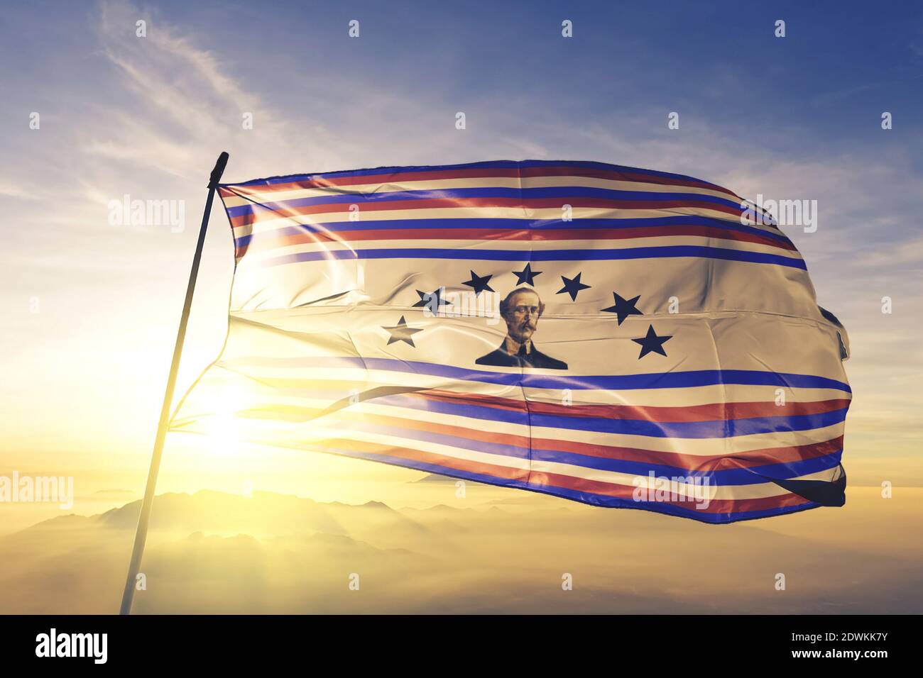 Duarte province of Dominican Republic flag waving on the top sunrise mist fog Stock Photo