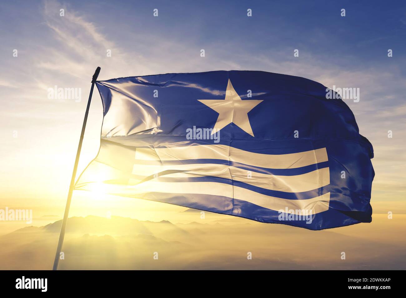 Azua province of Dominican Republic flag waving on the top sunrise mist ...