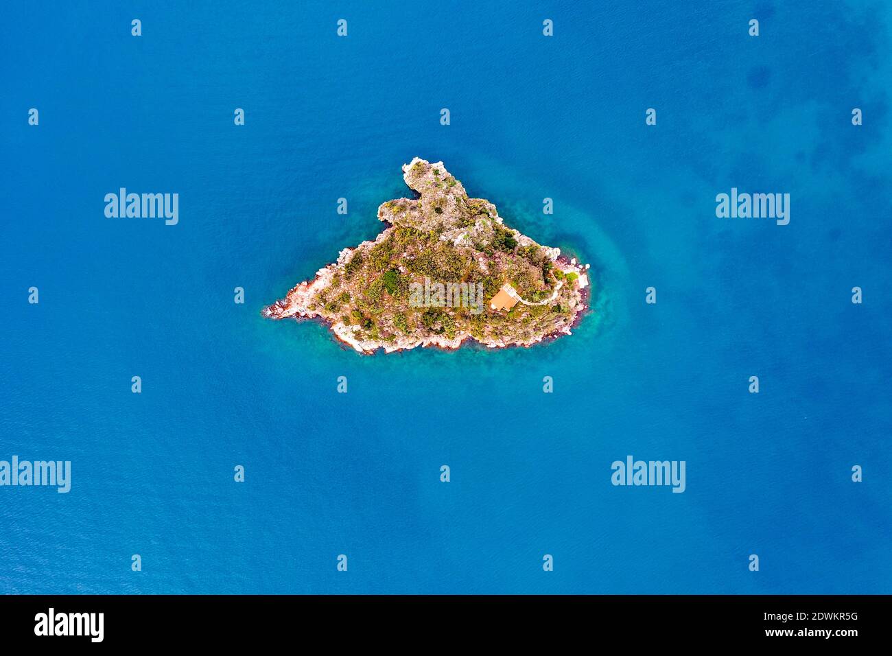 Top down aerial view of small rock island Stock Photo