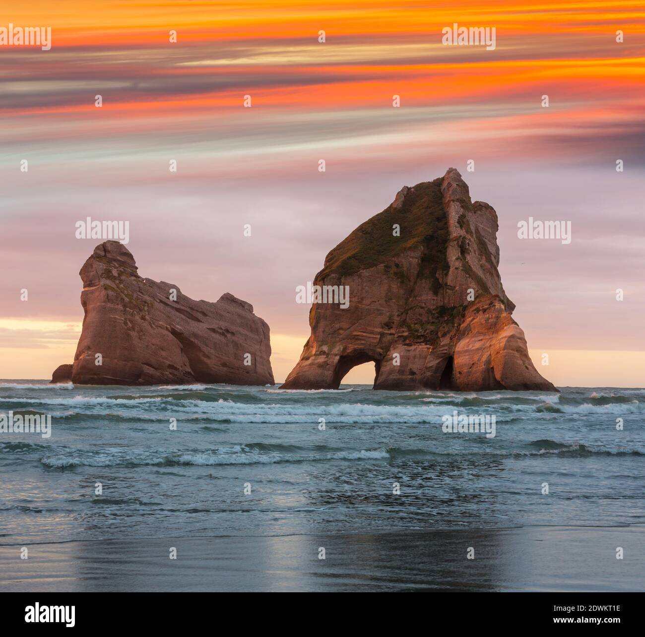 The Archway Islands of Wharariki Beach at sunset in New Zealand Stock Photo