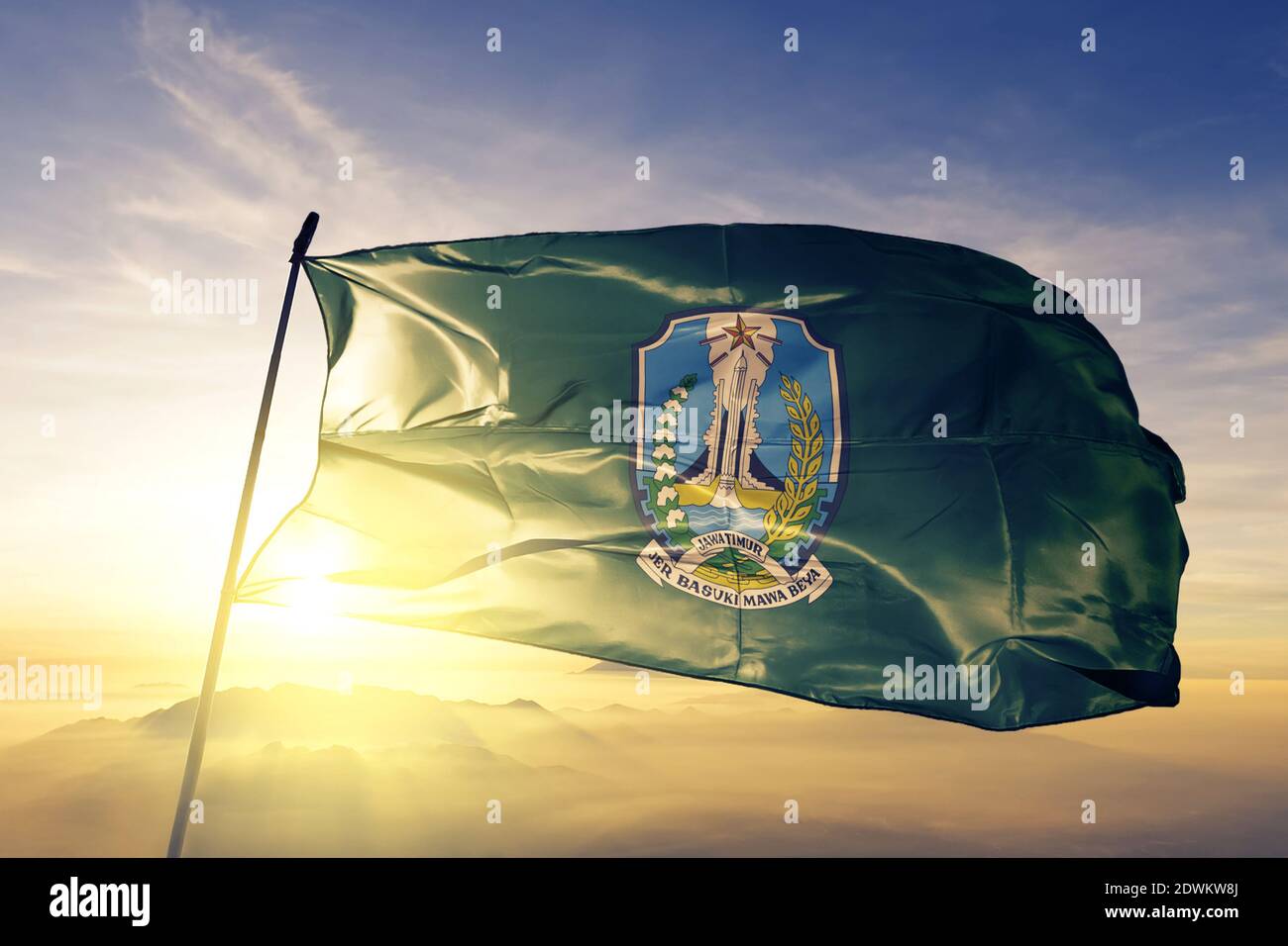 East Java province of Indonesia flag waving on the top sunrise mist fog