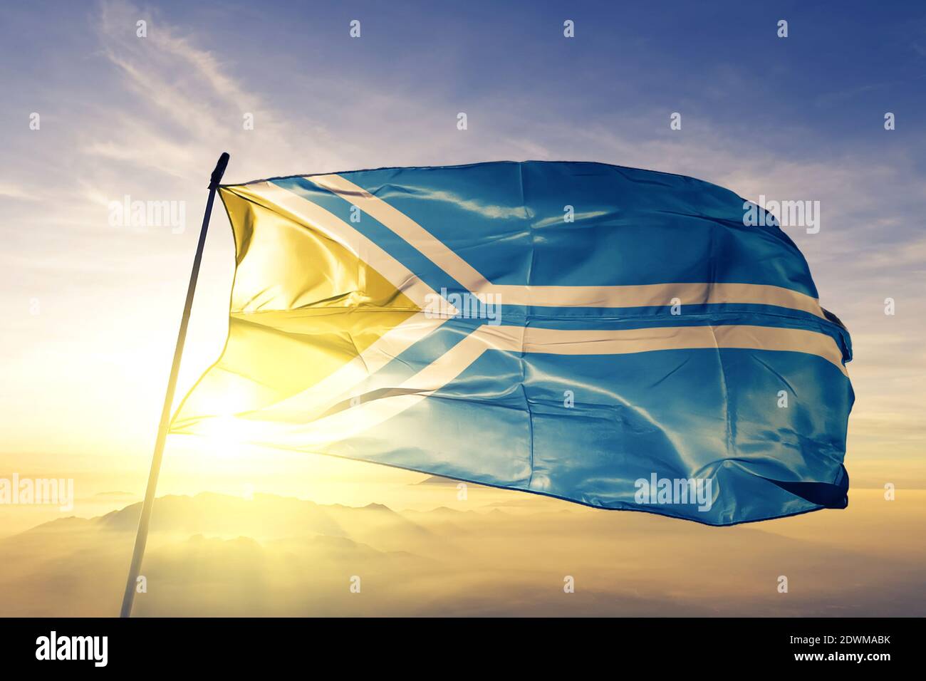 Tuva oblast Republic of Russia flag waving on the top sunrise mist fog Stock Photo