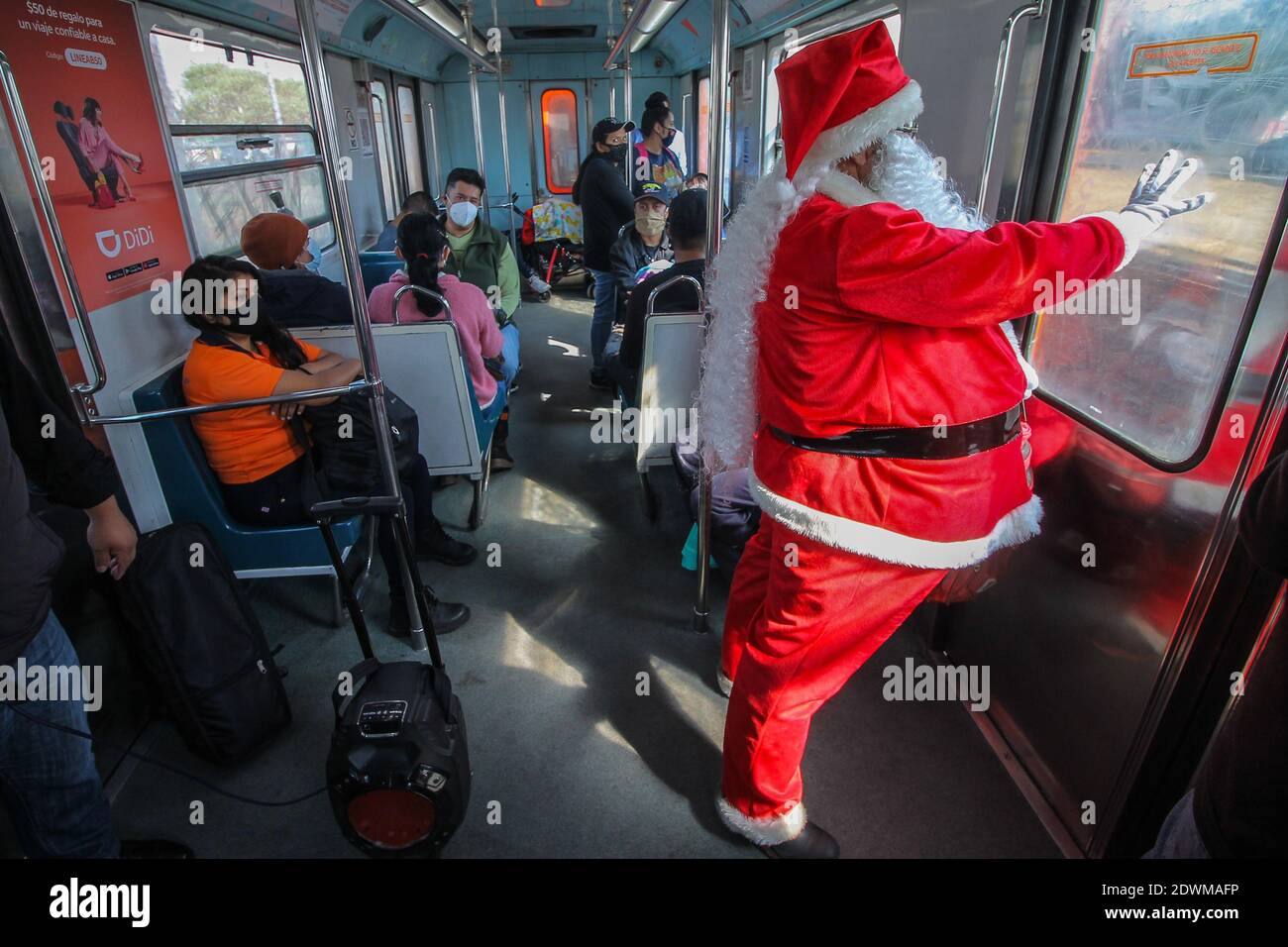 Non Exclusive: MEXICO CITY, MEXICO - DECEMBER 22: A person disguised as Santa  Claus rides on subway to celebrates Christmas eve On December 22, 2020 i  Stock Photo - Alamy