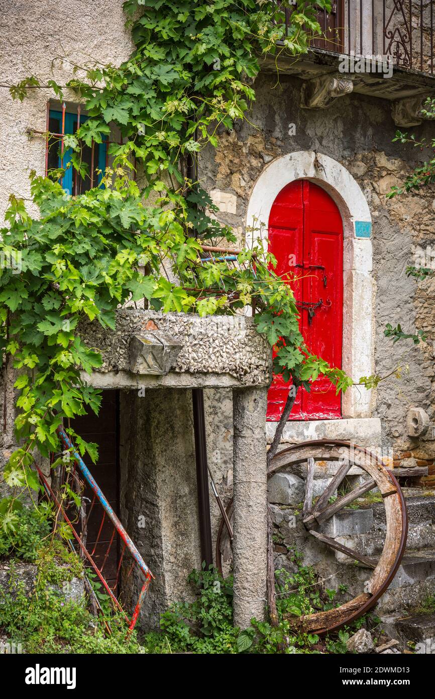 Spontaneous architecture in mountain village with red door Stock Photo