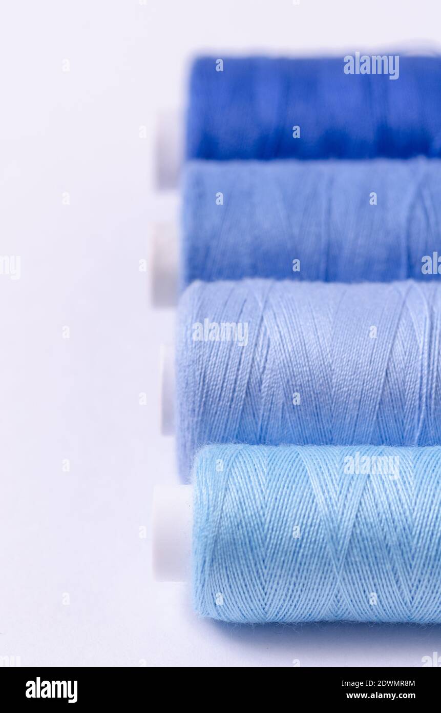 Spool with dark blue thread for sewing, supply for sewing, isolated object,  close-up macro with fine details, png on transparent background Stock Photo