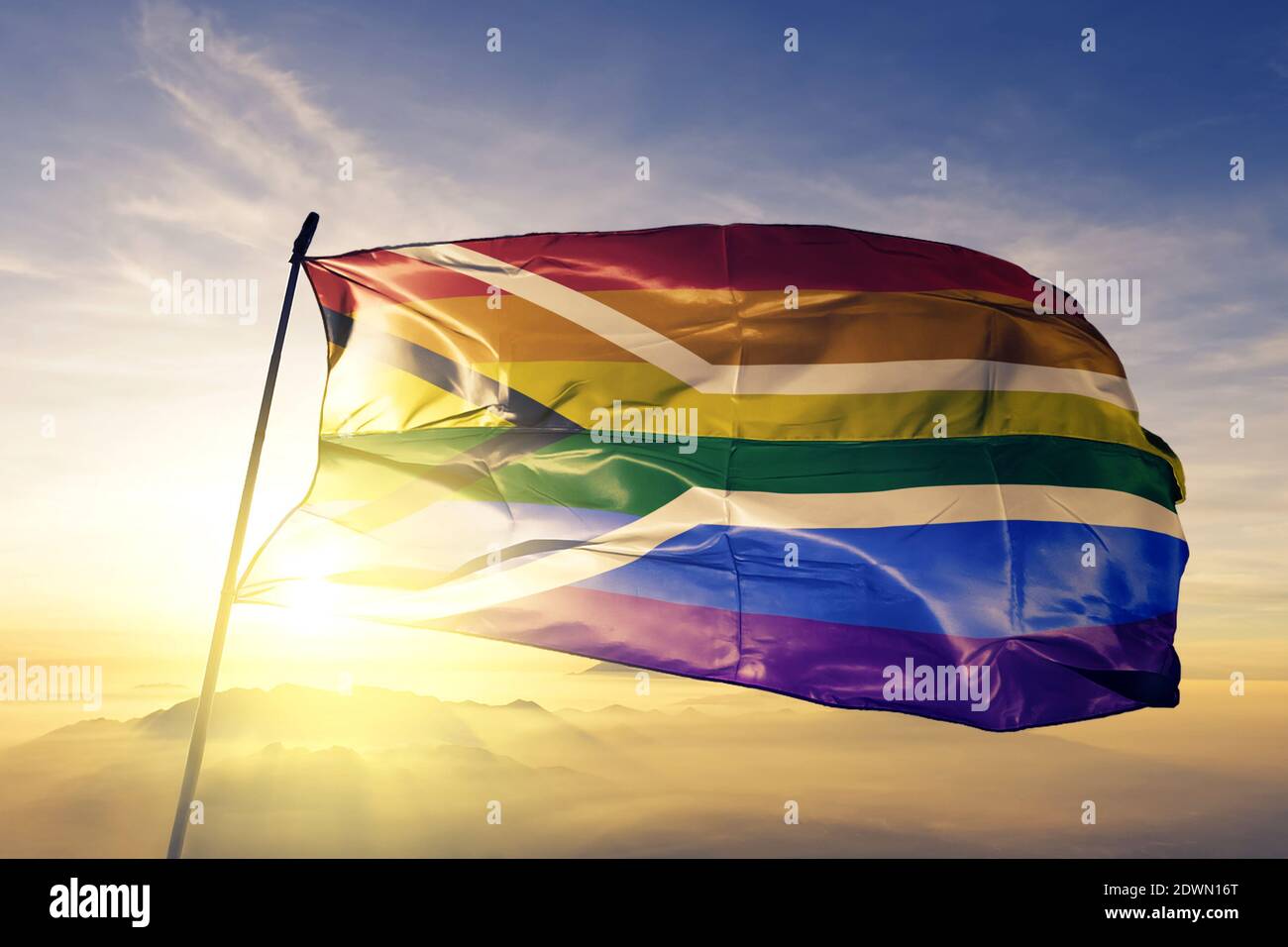 Gay pride of South Africa flag waving on the top sunrise mist fog Stock