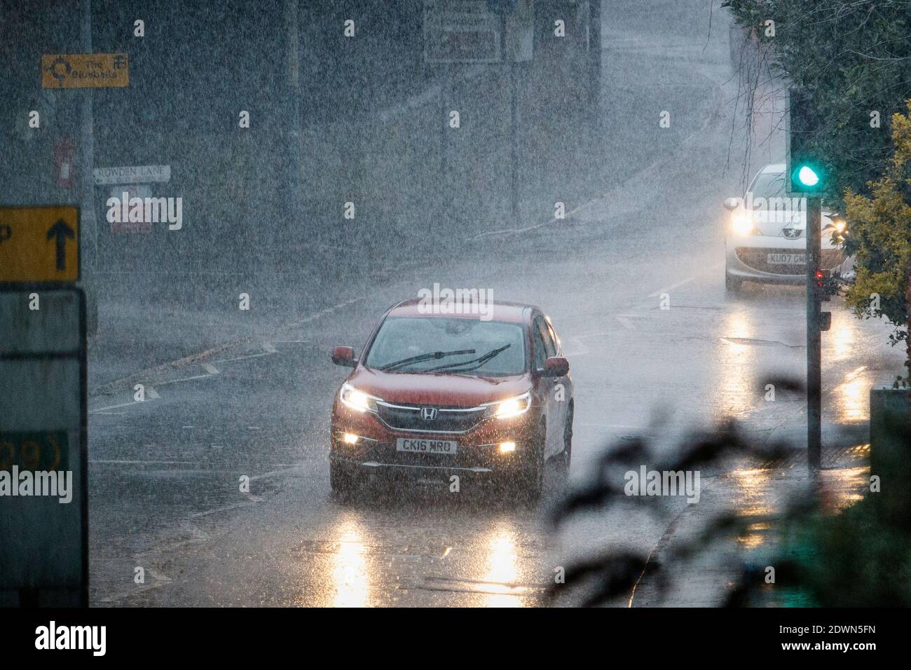 Chippenham, Wiltshire, UK. 23rd December, 2020. As torrential showers affect many parts of the UK, drivers are pictured braving very heavy rain in Chippenham. Credit: Lynchpics/Alamy Live News Stock Photo