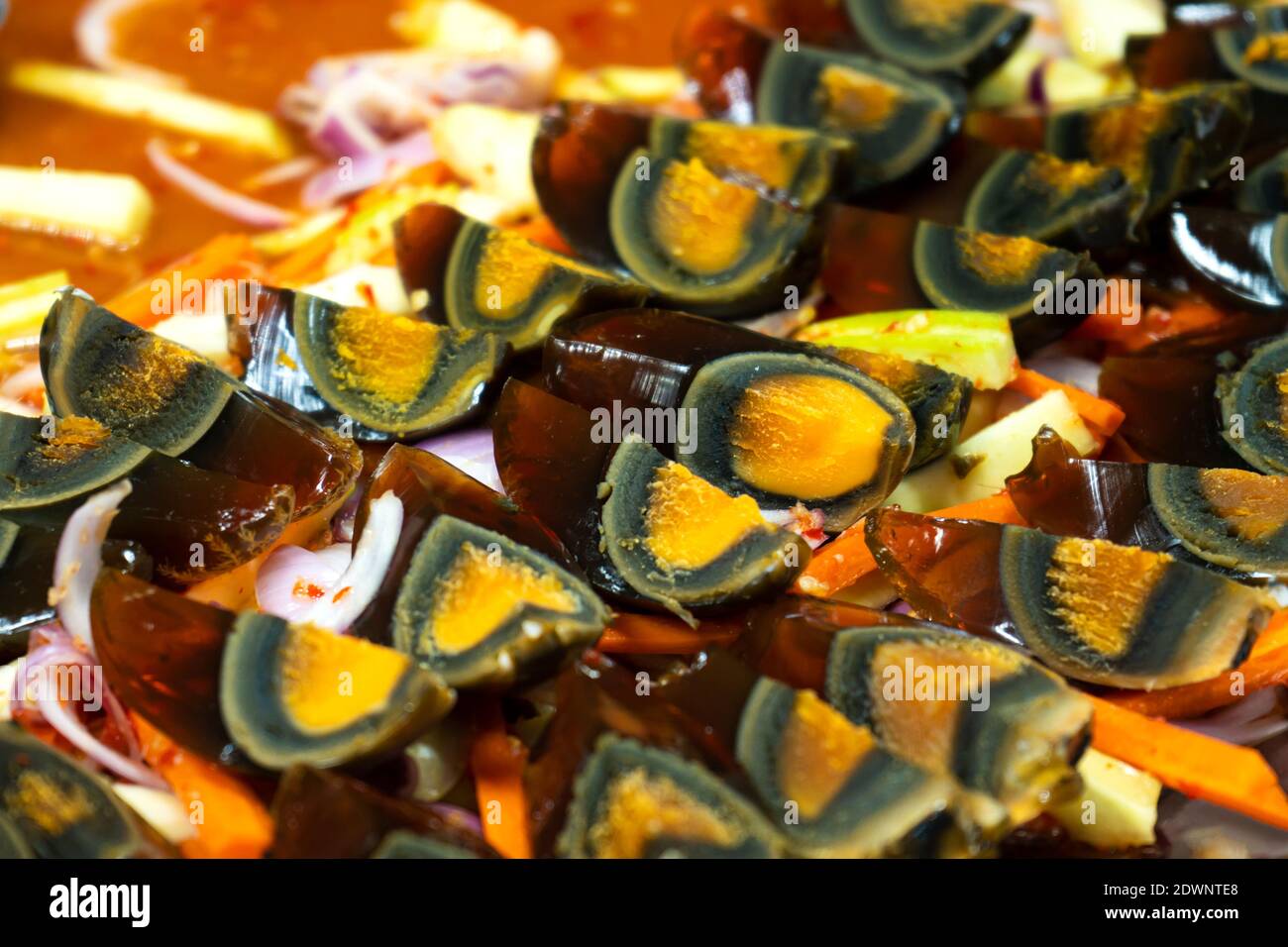 Street food market in Asia. A closeup, traditional dish of sliced pickled chicken eggs Stock