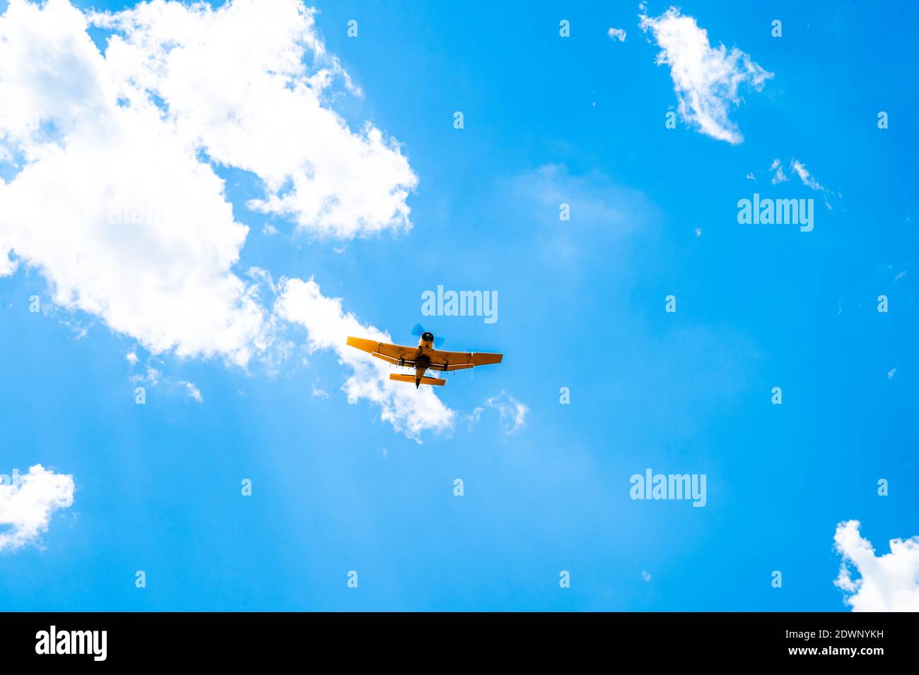 plane with spray on crops in the sky Stock Photo