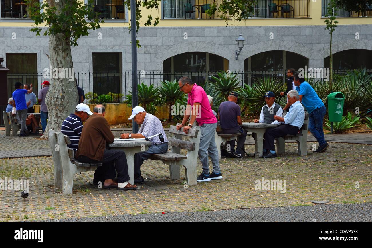 Older men socialising and playing games in Funchal Madeira Portugal. Stock Photo