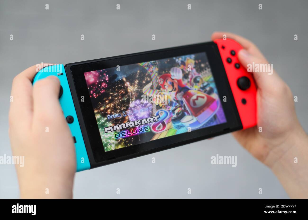 A teenager playing Mario Kart on a Nintendo Switch computer game console Stock Photo