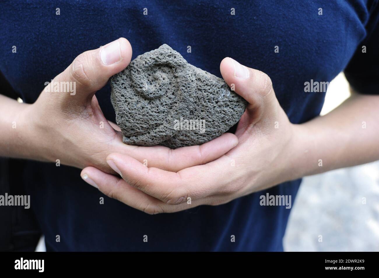 A closeup of male hands holding Aztec power stone Stock Photo