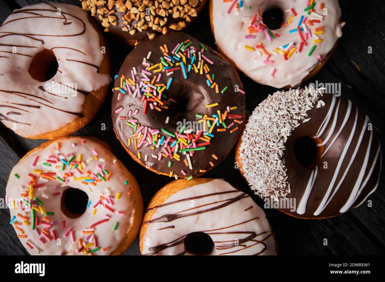 Colorful donuts on stone table. Top view with copy space Stock Photo