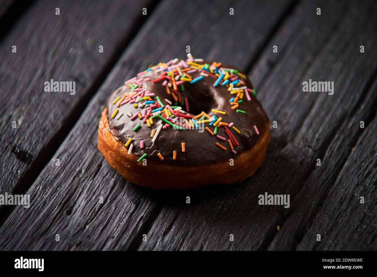 Colorful donuts on stone table. Top view with copy space Stock Photo