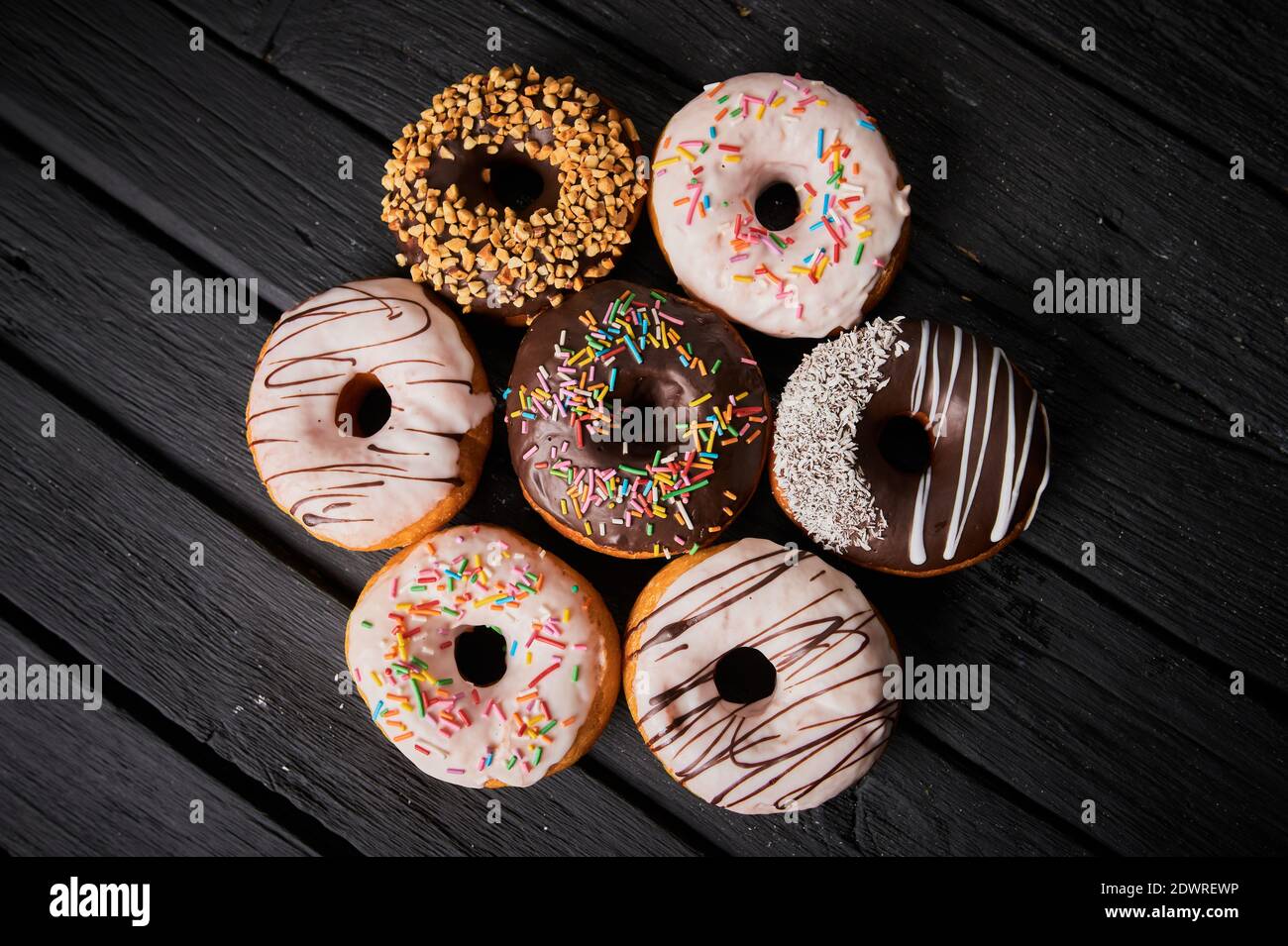 Colorful donuts on stone table. Top view with copy space Stock Photo ...