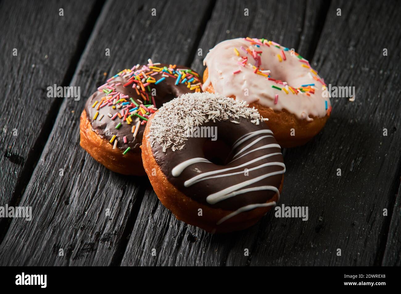 Colorful donuts on stone table. Top view with copy space Stock Photo