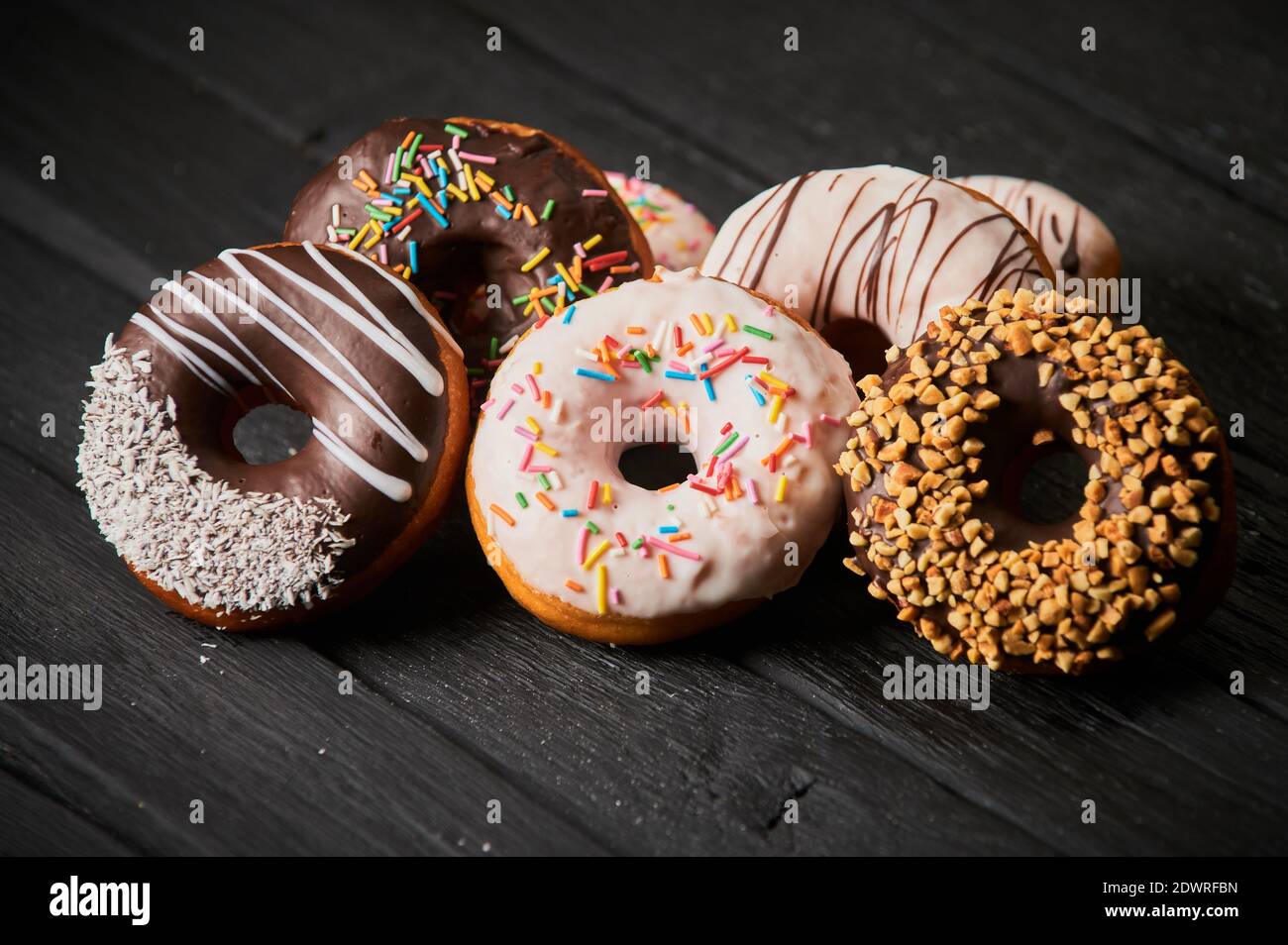 Colorful donuts on stone table. Top view with copy space Stock Photo