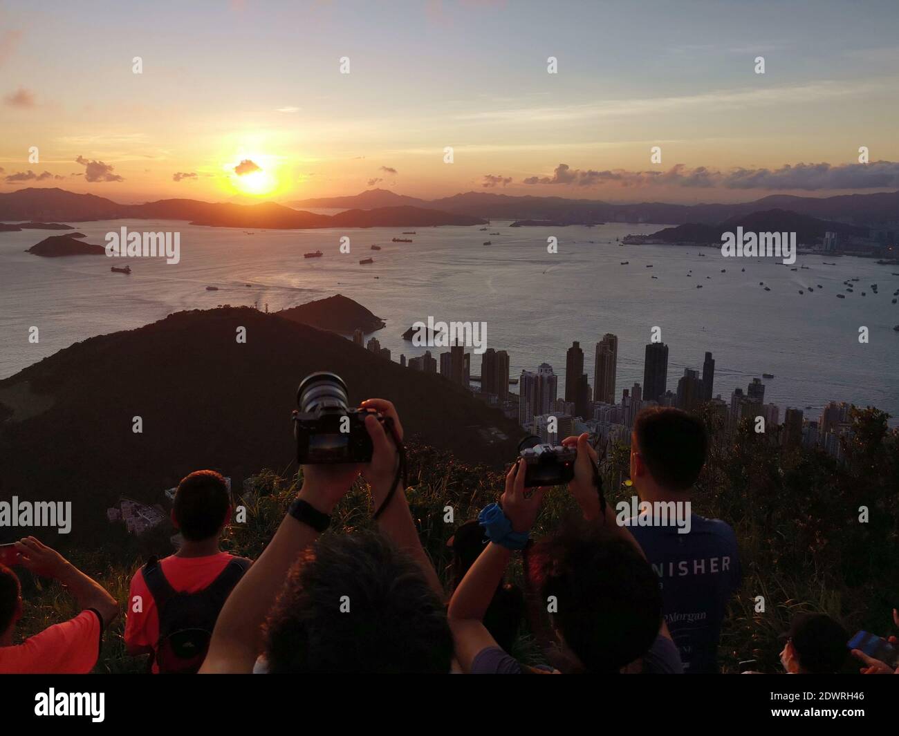 Hong Kong, China. 20th June, 2020. People watch sunset in Hong Kong, south China, June 20, 2020. Credit: Li Gang/Xinhua/Alamy Live News Stock Photo