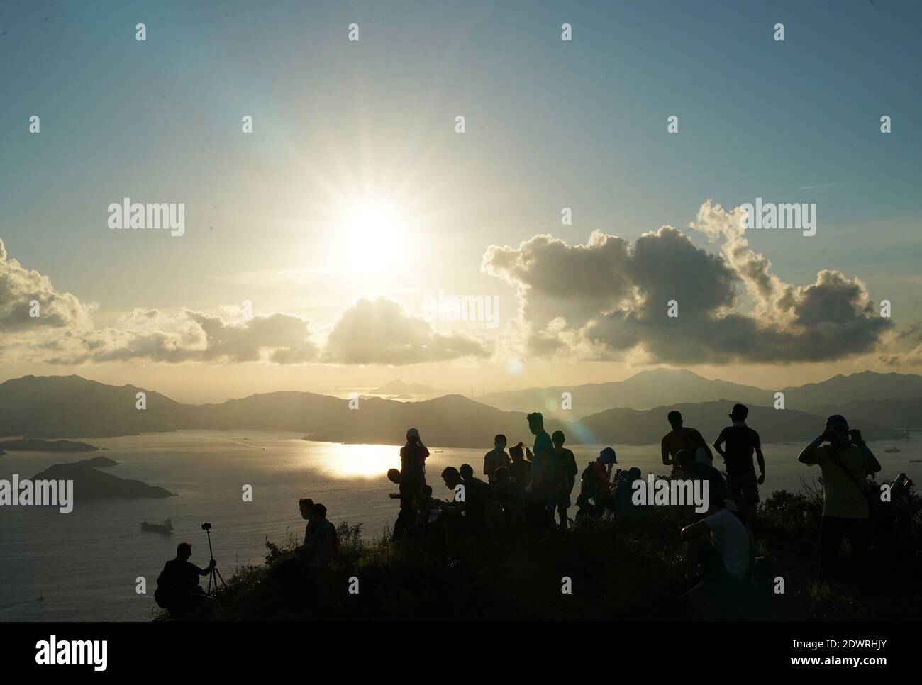 Hong Kong, China. 20th June, 2020. People watch sunset in Hong Kong, south China, June 20, 2020. Credit: Li Gang/Xinhua/Alamy Live News Stock Photo