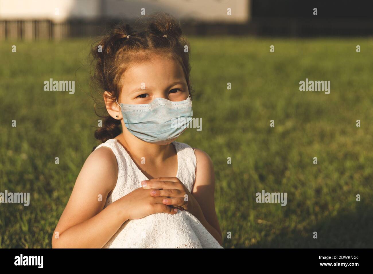 little girl in a white dress on the lawn in summer Stock Photo - Alamy