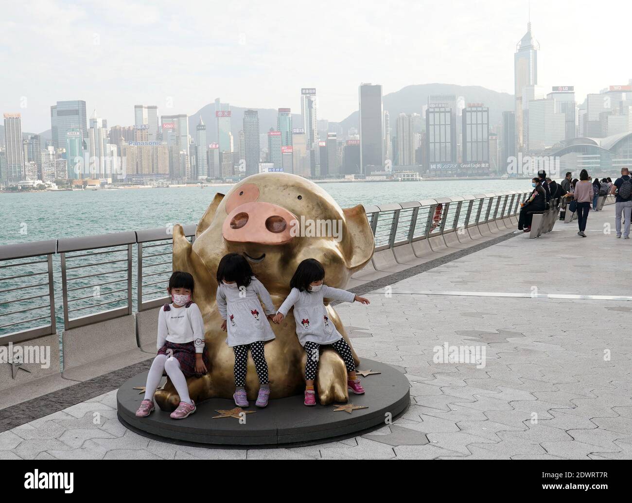 Hong Kong, China. 23rd Feb, 2020. Children wearing face masks play by the sea in Hong Kong, south China, Feb. 23, 2020. Credit: Li Gang/Xinhua/Alamy Live News Stock Photo