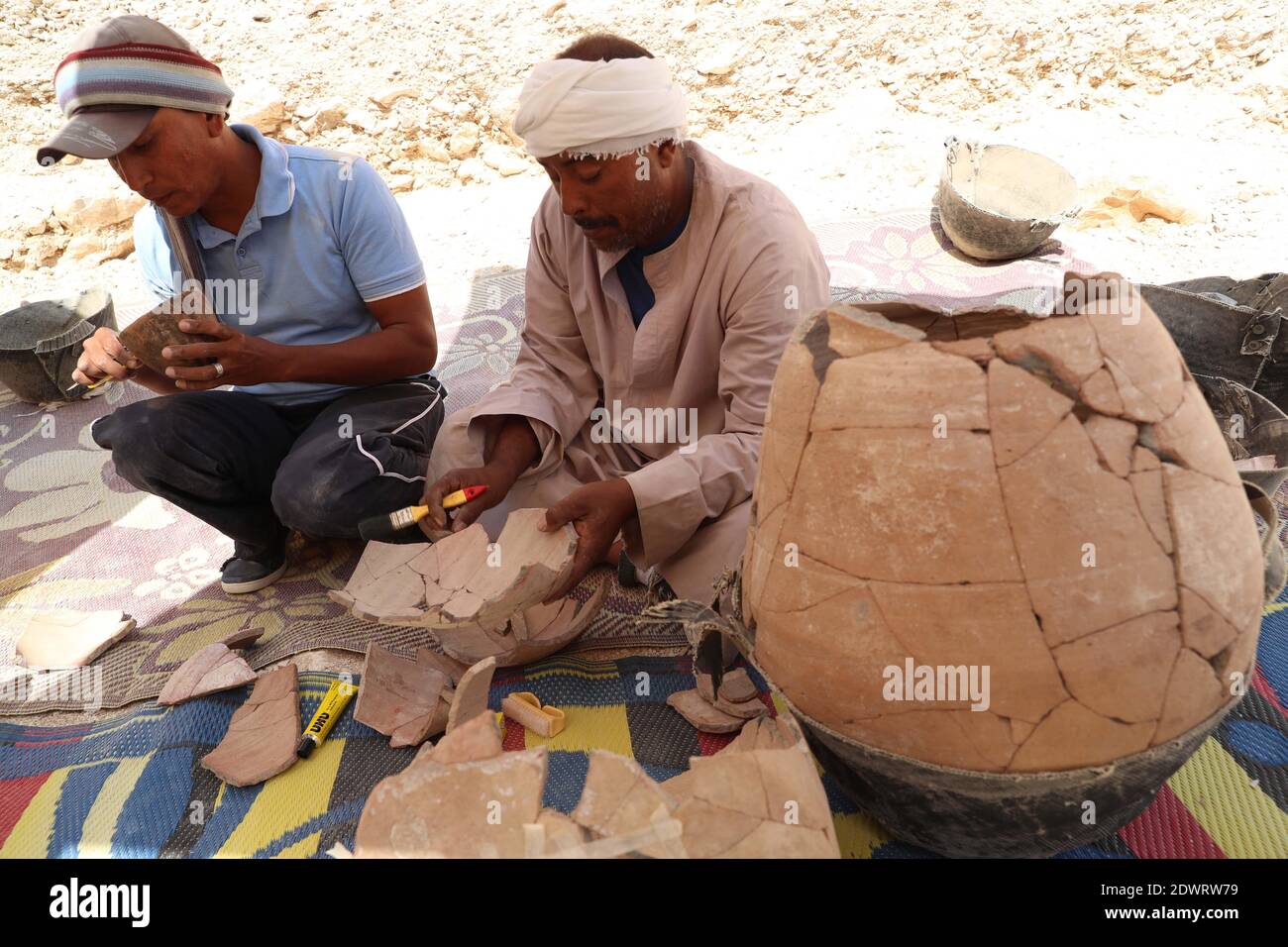 Luxor, Egypt. 10th Oct, 2019. Excavation workers clean artefacts in Luxor, Egypt, Oct. 10, 2019. TO GO WITH 'Feature: With love of antiquities, Egyptian family devotes a century to excavation works' Credit: Ahmed Gomaa/Xinhua/Alamy Live News Stock Photo