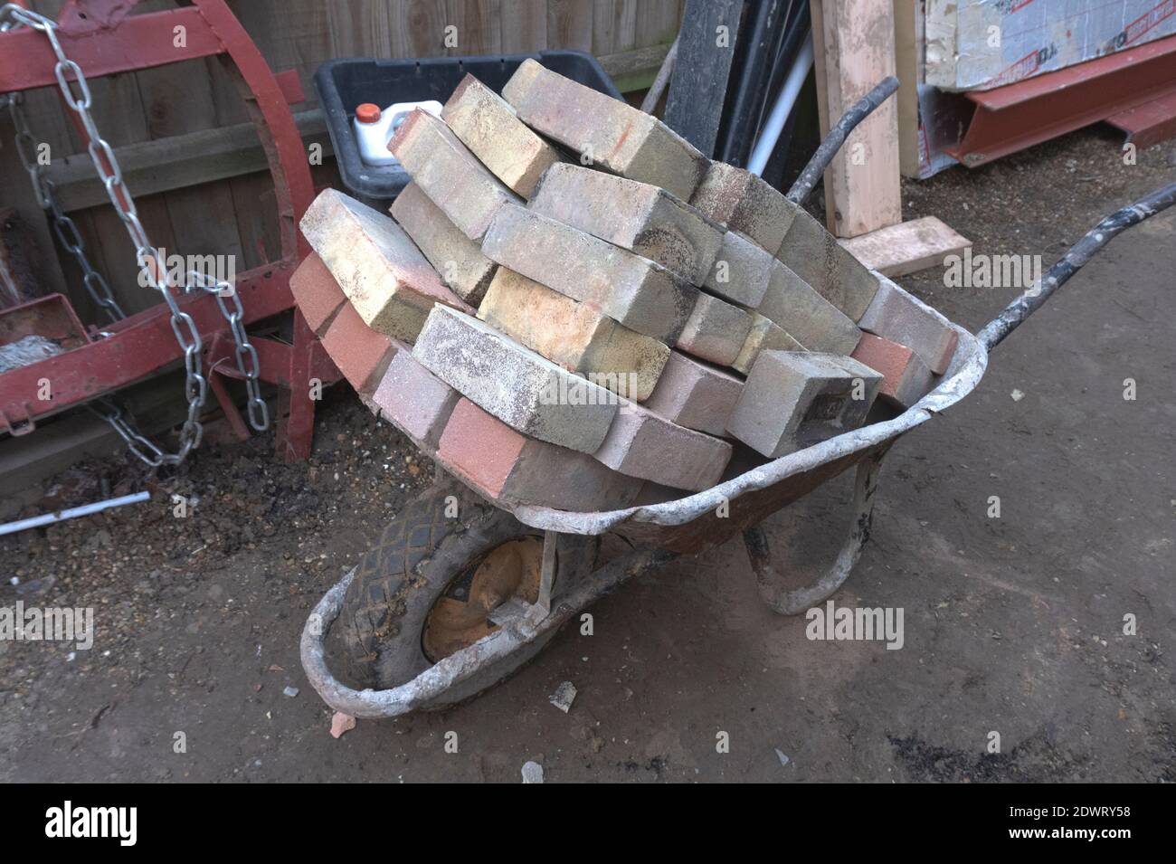 builder wheelbarrow with load of bricks Stock Photo