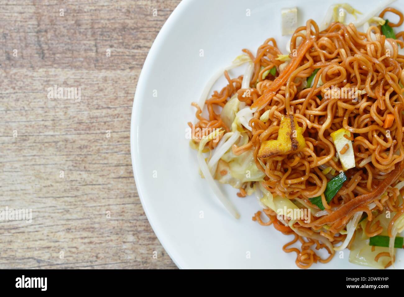 fried instant noodles with tofu and garlic chive on plate Stock Photo