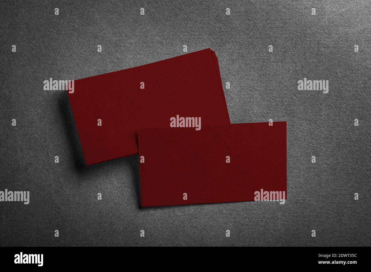 Stack of blank dark red business card on grey textured background top view. Identify design, corporate templates. Stock Photo