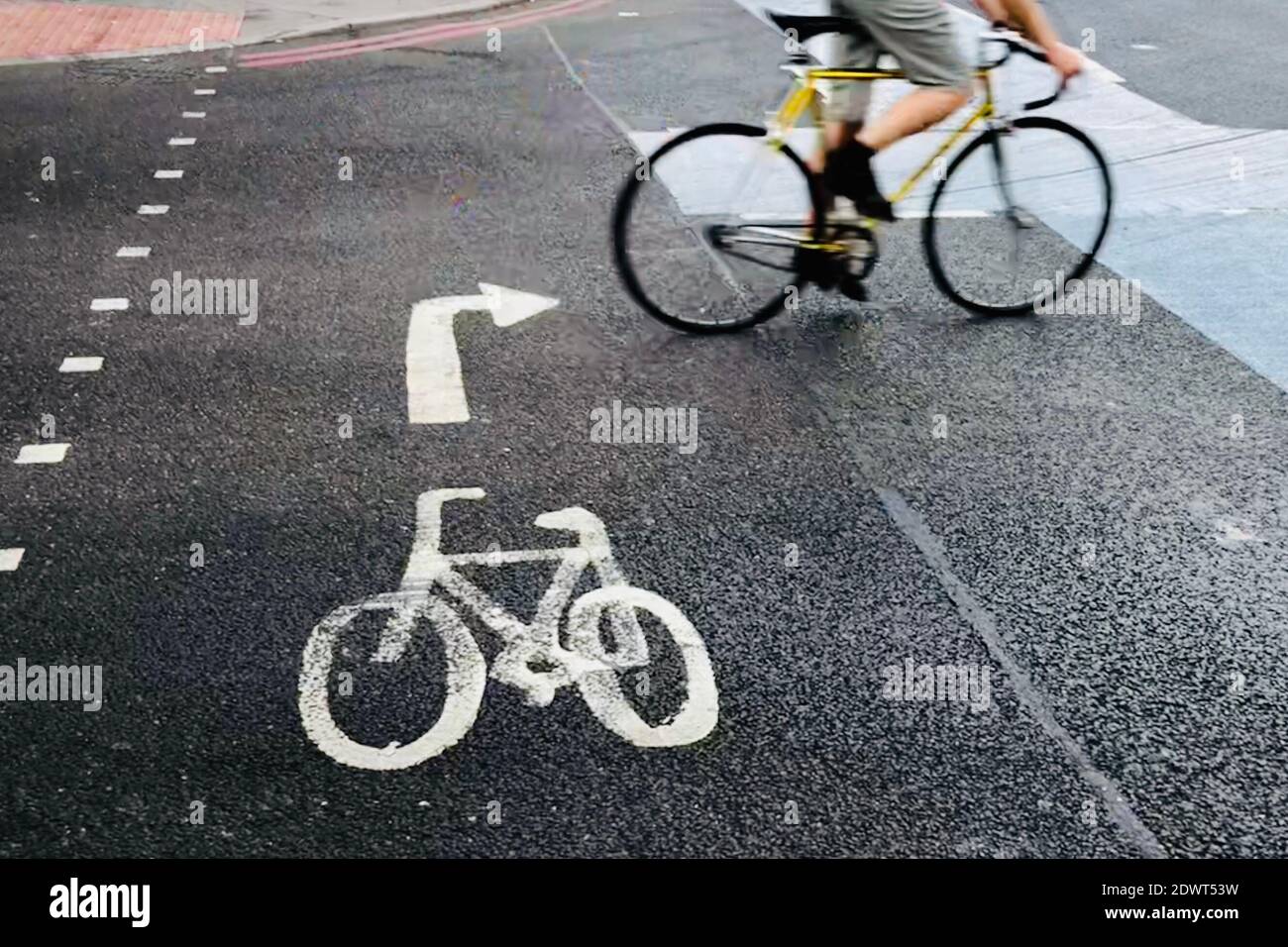 Low Section Of Man Cycling On Street In City Stock Photo