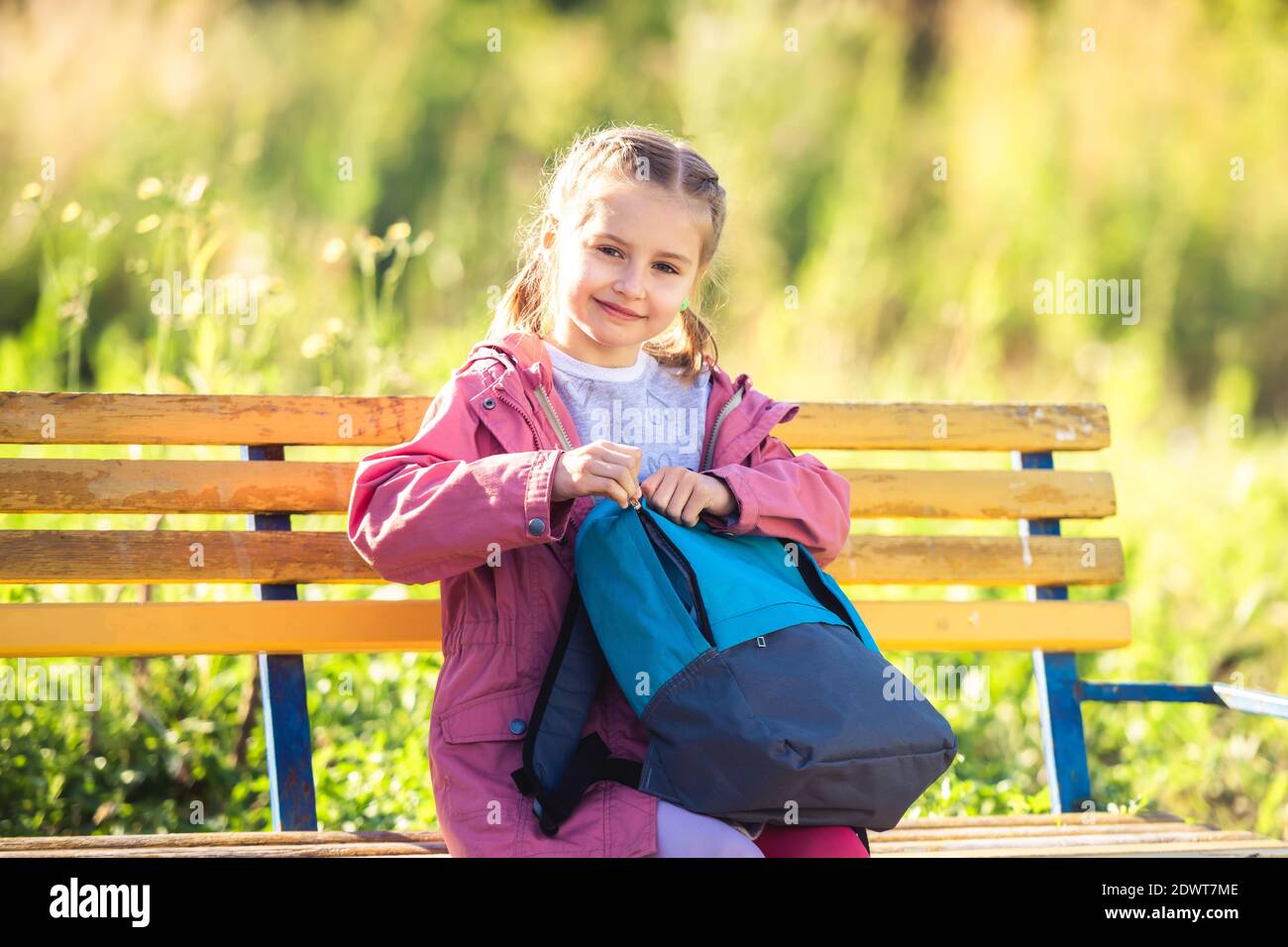 School girl sitting on bench hi-res stock photography and images - Alamy