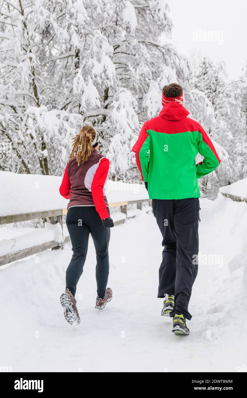 Two joggers during running workout in wintry nature Stock Photo