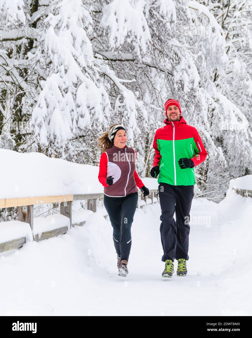 Two joggers during running workout in wintry nature Stock Photo
