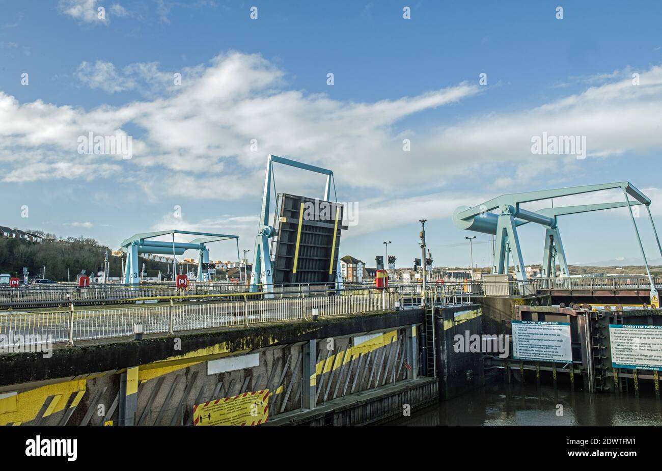 Three bascule bridges allowing access to the sea from Cardiff Bay, the middle one opening to allow a yacht through, Cardiff. Stock Photo