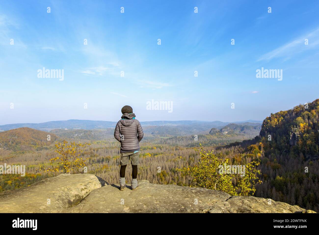 woman stands on the edge of sandstone rock in national park saxony switzerland, sächsische schweiz, elbsandsteingebirge, idagrotte, lookout Stock Photo