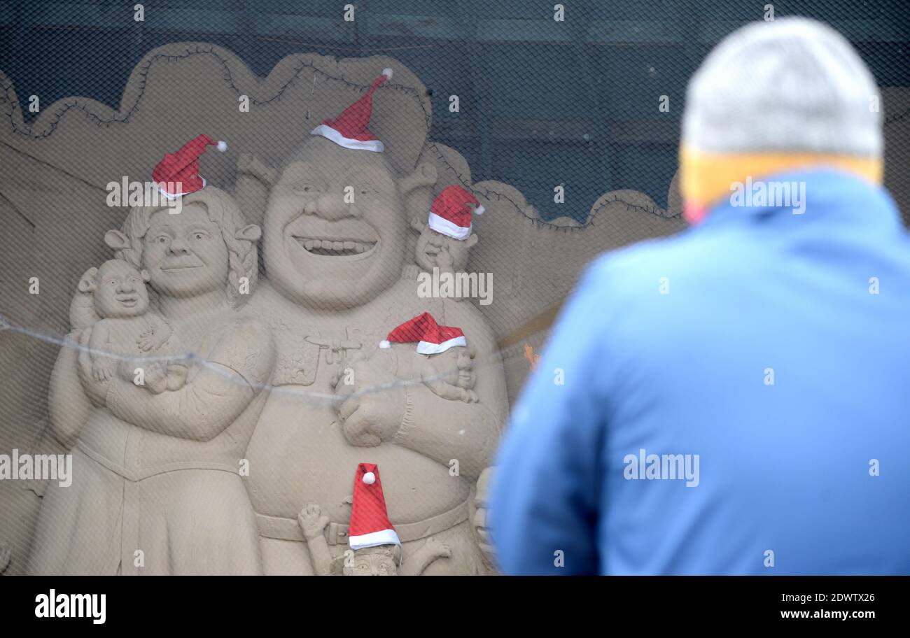 Weymouth, Dorset, UK. 23rd Dec 2020. Festive sand sculpture of Shrek and family wearing Santa hats is seen in Weymouth, Dorset, UK. Picture by Credit: Dorset Media Service/Alamy Live News Stock Photo